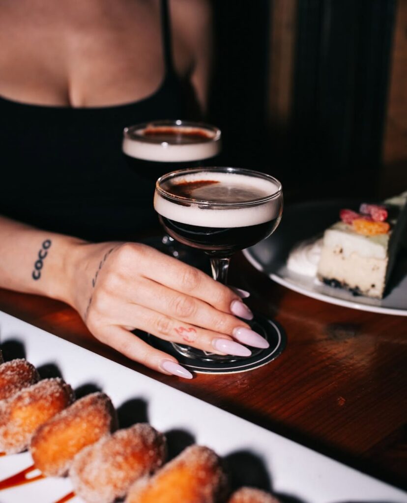 Close-up of espresso martinis and cinnamon mini donuts served at Warehouse for the perfect dessert pairing.