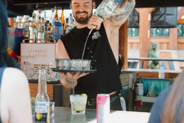 A bartender serving drinks at the patio party by Warehouse in Toronto.