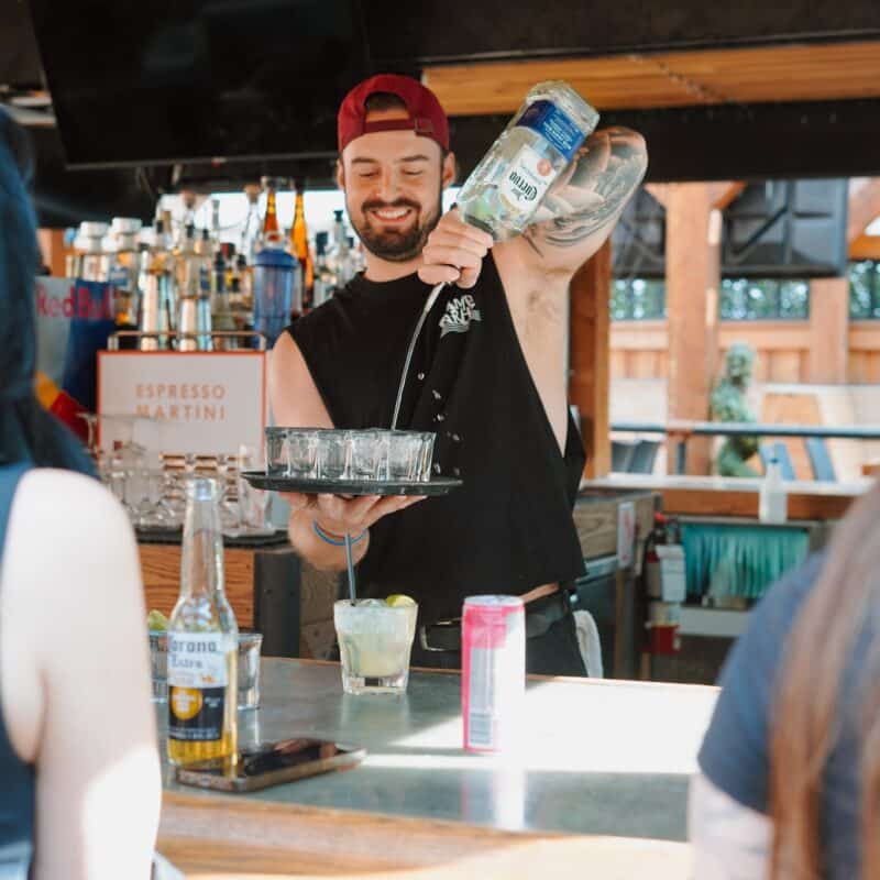 A bartender serving drinks at the patio party by Warehouse in Toronto.
