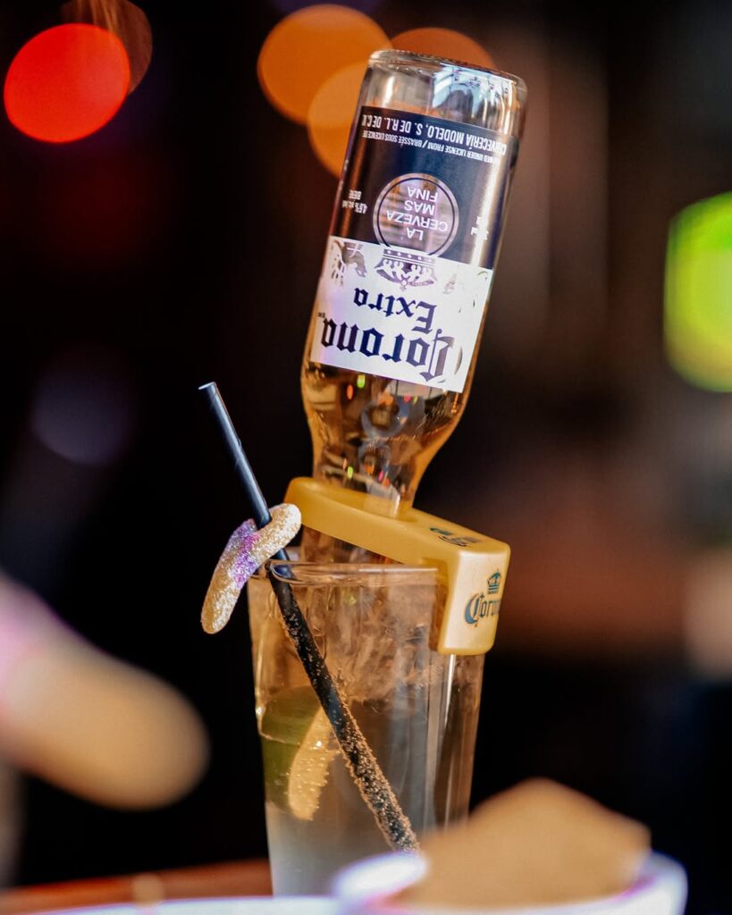 Corona beer bottle served upside down in a Pink Warehouse cocktail at Warehouse Edmonton.