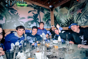 A Group of friends gathered around with drinks, geared up for the NHL.