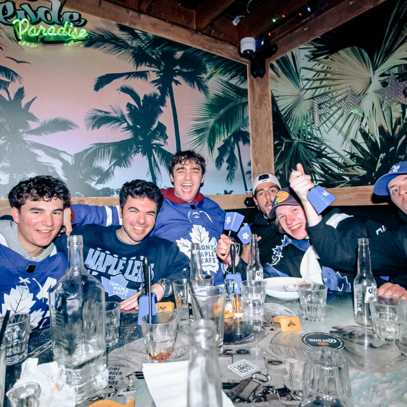A Group of friends gathered around with drinks, geared up for the NHL.