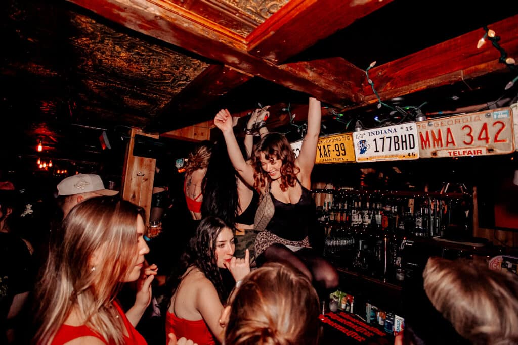  A group of co-workers having a great time at the party thrown at Warehouse. 