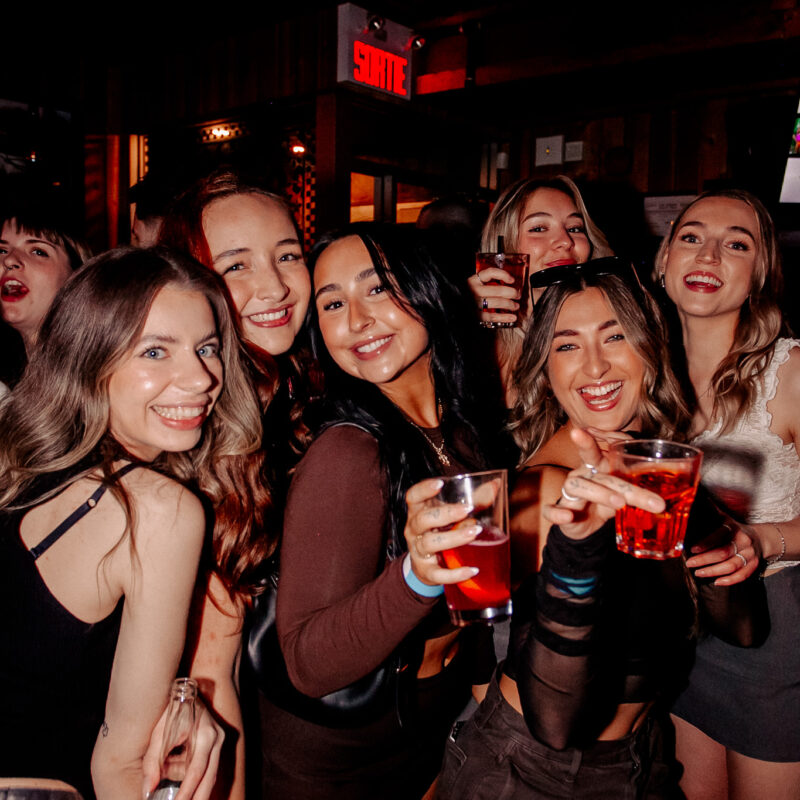 Six women posing with drinks at Warehouse Whistler