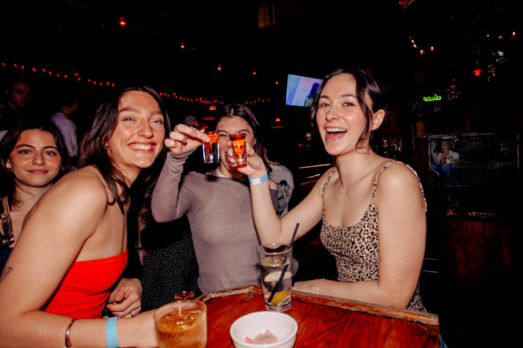 Group of friends enjoying cocktails and drinks together at Warehouse Toronto during a soccer match night.