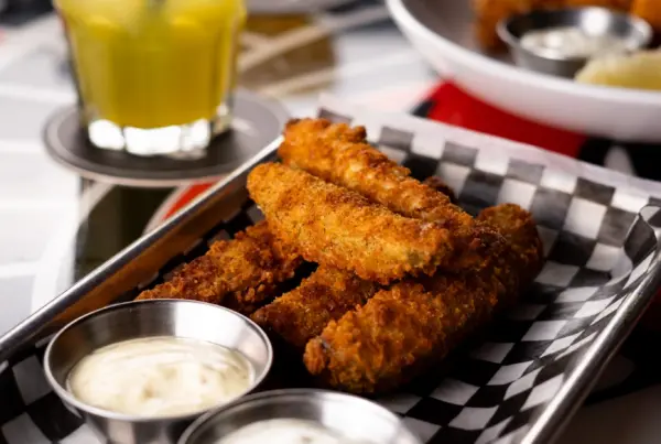 Fries, dipping sauces, and a drink on a table at Warehouse in Victoria.
