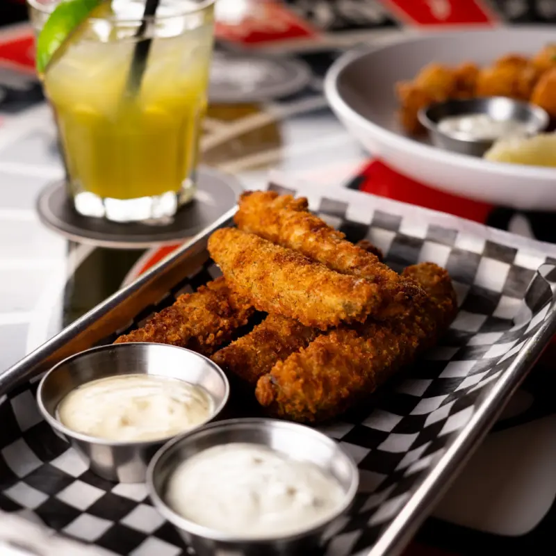 Fries, dipping sauces, and a drink on a table at Warehouse in Victoria.