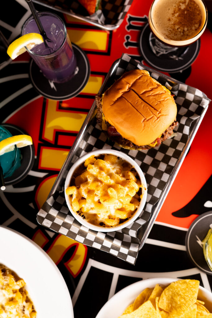 Cheeseburger and mac and cheese served on a checkered tray at Warehouse.